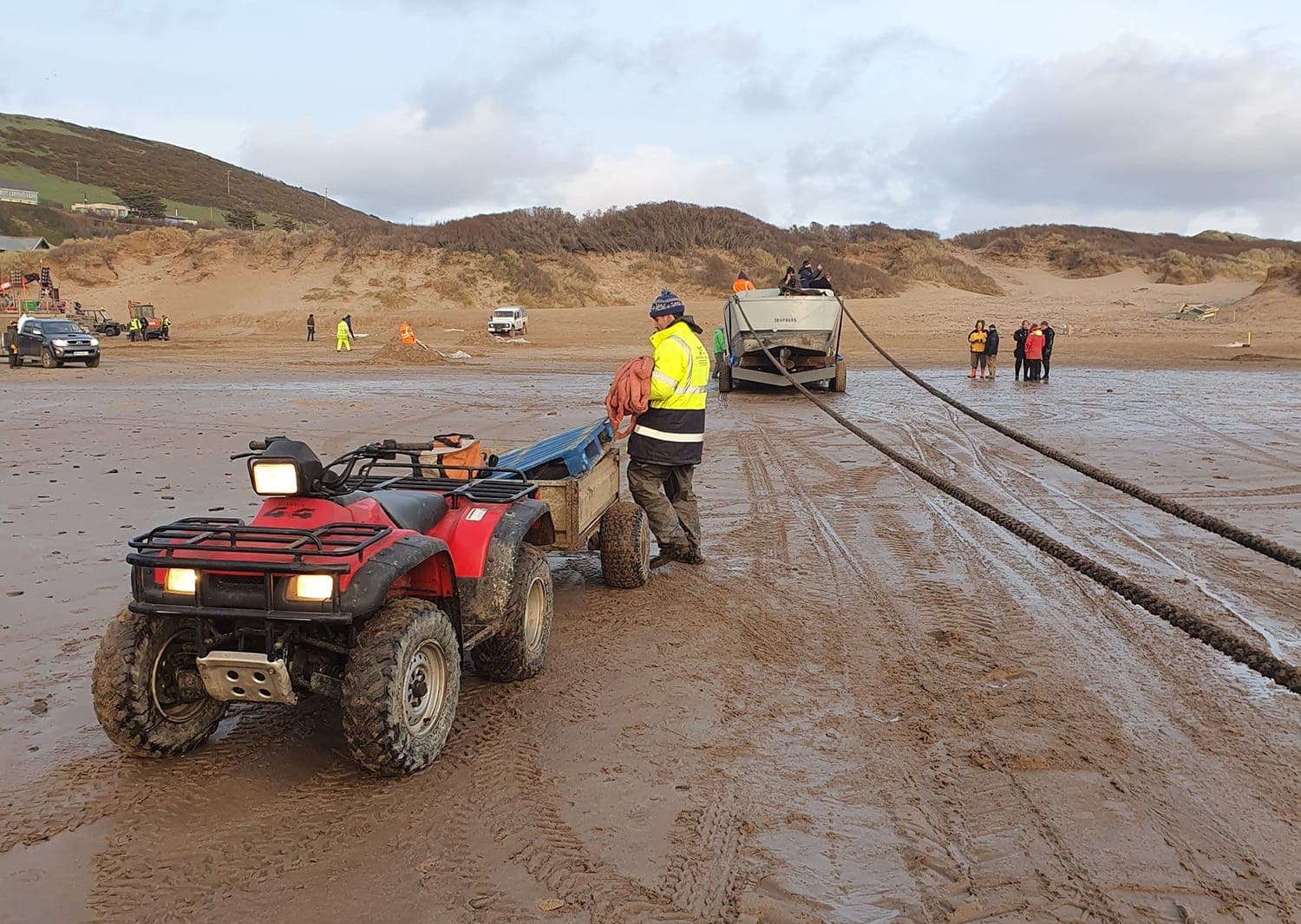 Crew installing temporary trackway and equipment beside the coast
