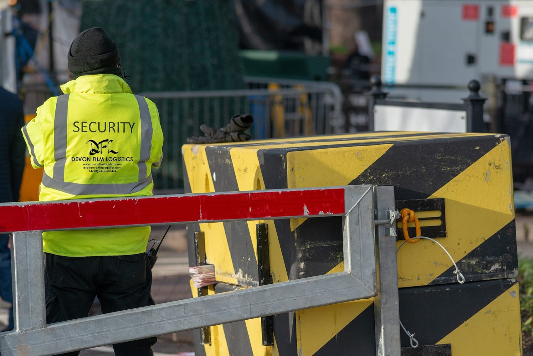 DFL security guard controlling access beside a barrier