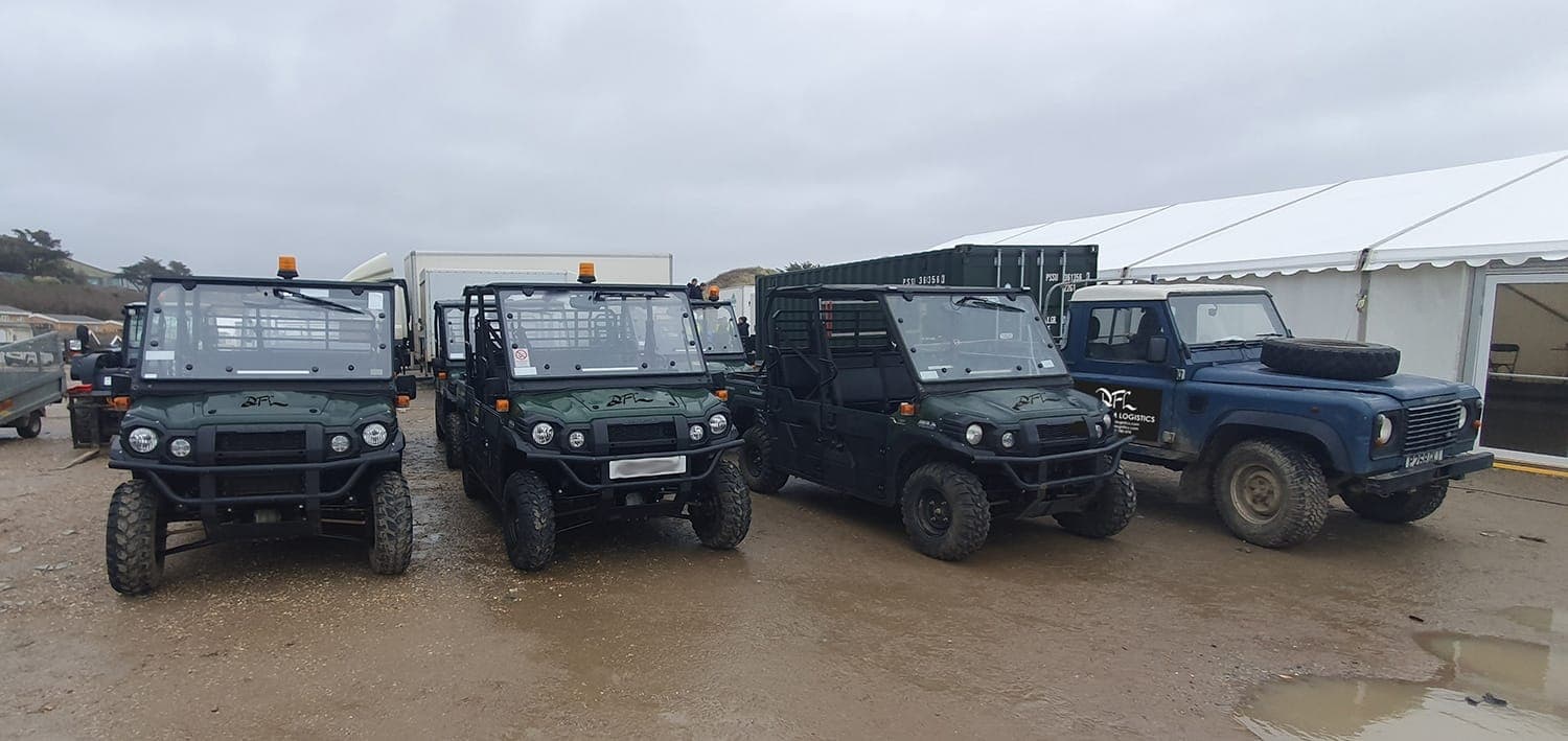 Four DFL utility vehicles and a four-wheel-drive vehicle lined up at a unit base
