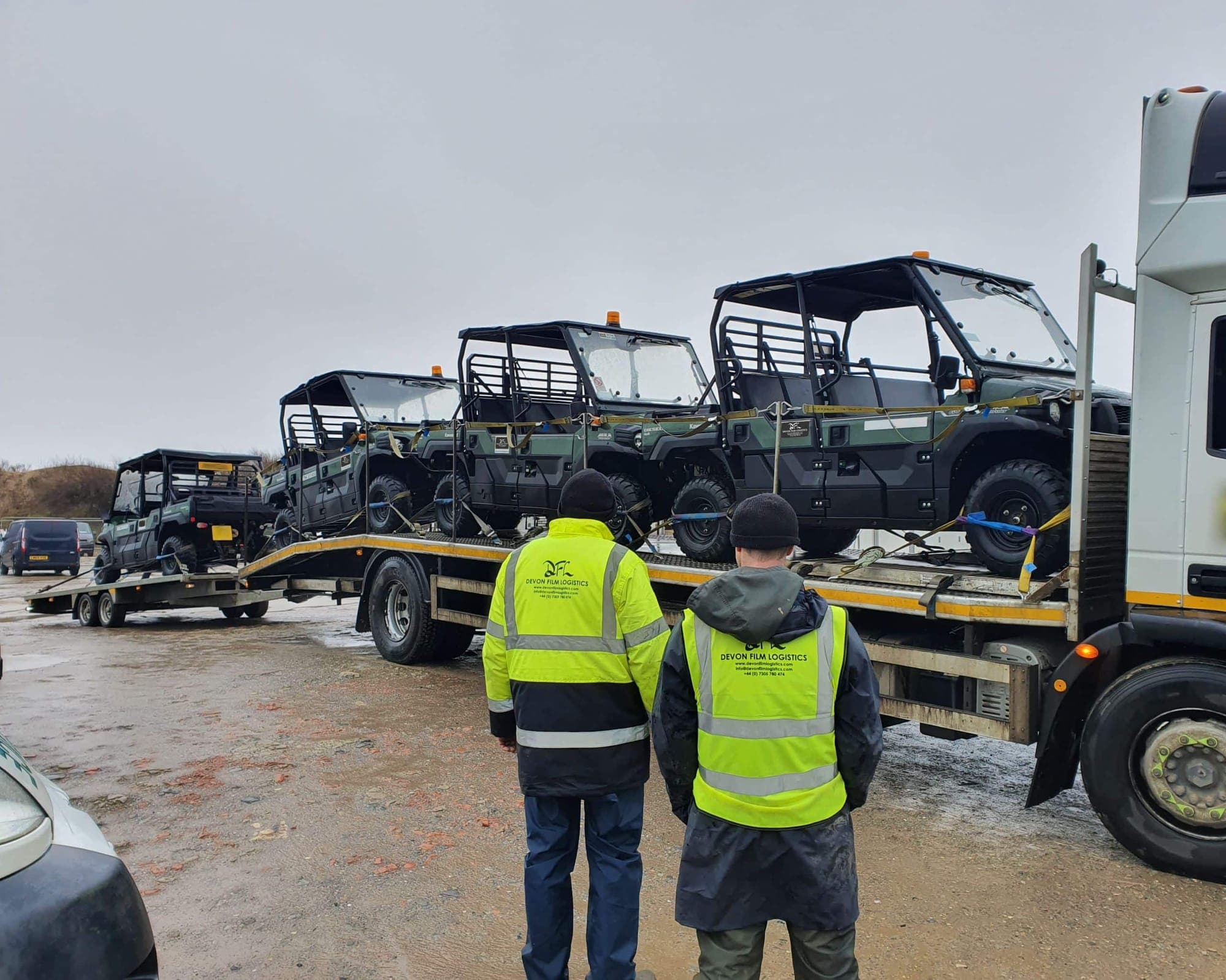 DFL crew unloading utility vehicles from transport trailers