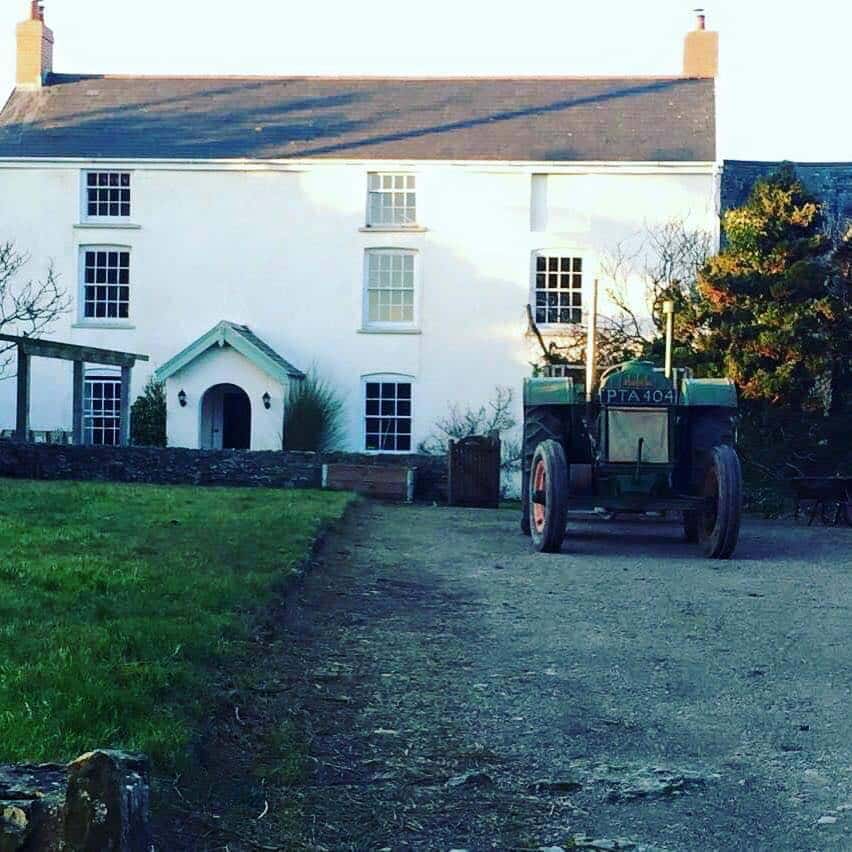 Period tractor parked outside a rural property