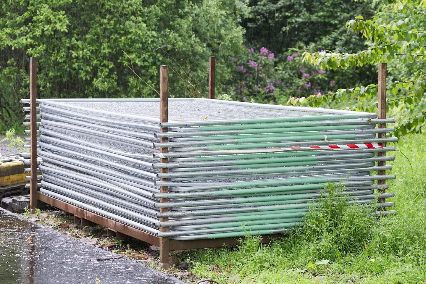Temporary mesh fencing panels stacked ready for deployment
